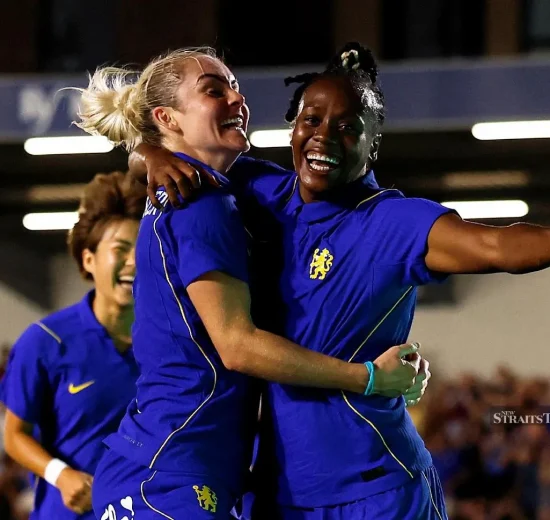 Melvine Malard (right) celebrates scoring with Ellie Carpenter during their Women’s Champions League match at Cherry Red Records Stadium, London, Britain, on Wednesday.