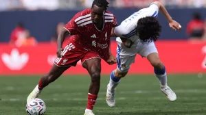 Jeremie Frimpong #30 of Liverpool is fouled by Ao Tanaka #22 of Leeds United during the first half of a preseason friendly at Soldier Field on August 2, 2026 in Chicago, Illinois.