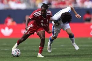 Jeremie Frimpong #30 of Liverpool is fouled by Ao Tanaka #22 of Leeds United during the first half of a preseason friendly at Soldier Field on August 2, 2026 in Chicago, Illinois.