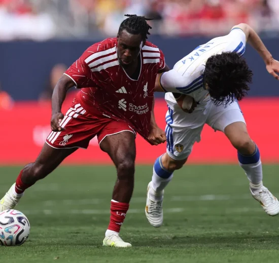 Jeremie Frimpong #30 of Liverpool is fouled by Ao Tanaka #22 of Leeds United during the first half of a preseason friendly at Soldier Field on August 2, 2026 in Chicago, Illinois.