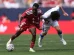 Jeremie Frimpong #30 of Liverpool is fouled by Ao Tanaka #22 of Leeds United during the first half of a preseason friendly at Soldier Field on August 2, 2026 in Chicago, Illinois.