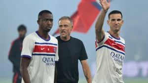 Paris Saint-Germain's Ecuadoran defender Willian Pacho, PSG's Spanish head coach Luis Enrique and PSG's Spanish midfielder Fabian Ruiz stand on the pitch before the start of the French L1 match between PSG and AS Monaco at the Parc des Princes stadium in Paris on September 4, 2026.