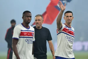 Paris Saint-Germain's Ecuadoran defender Willian Pacho, PSG's Spanish head coach Luis Enrique and PSG's Spanish midfielder Fabian Ruiz stand on the pitch before the start of the French L1 match between PSG and AS Monaco at the Parc des Princes stadium in Paris on September 4, 2026.